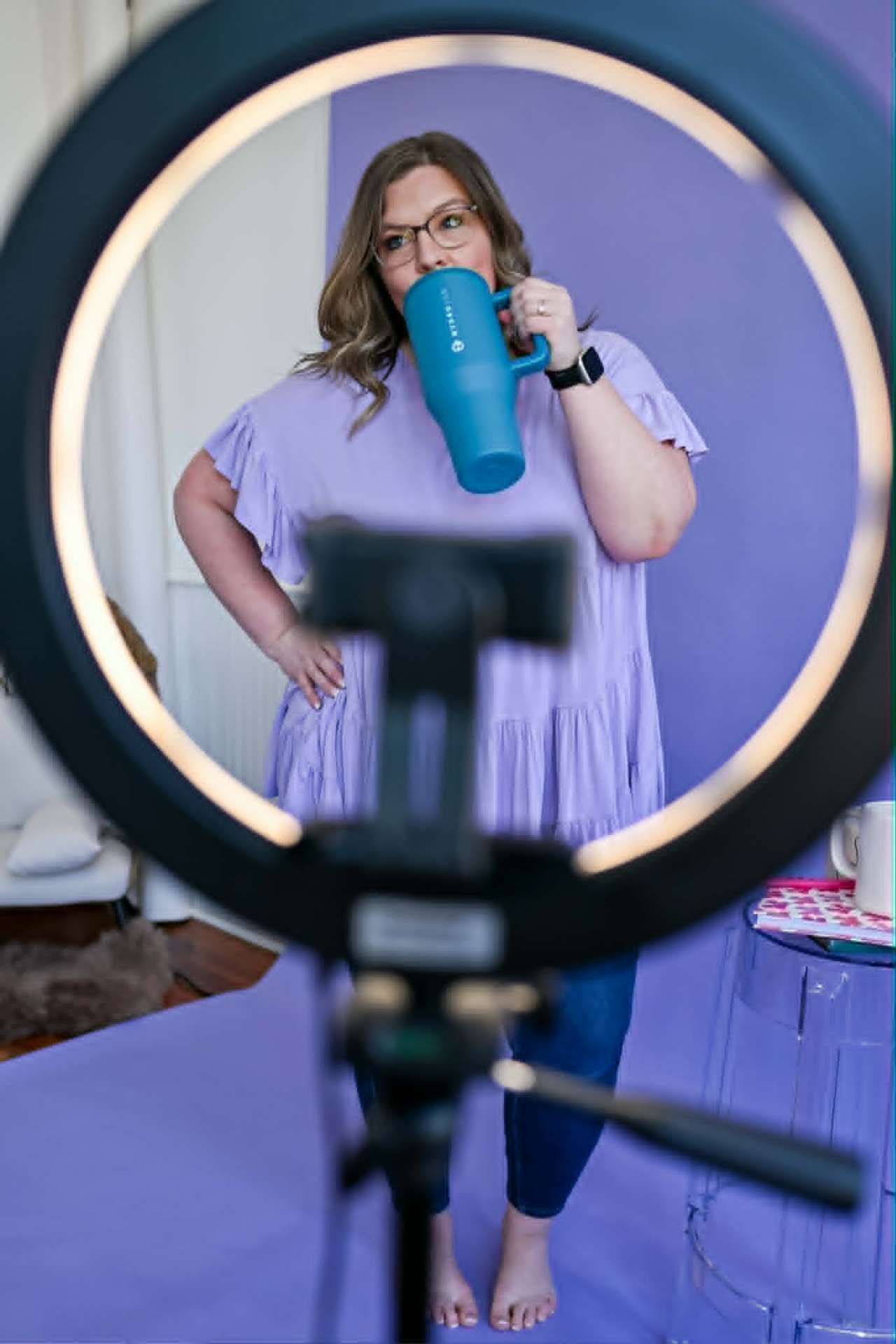 Filming a short video with a ring light and tripod setup